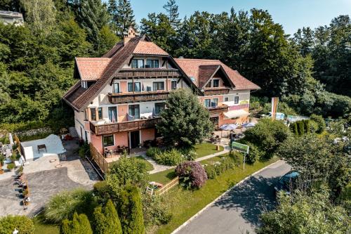 an aerial view of a large house with trees at Hotel Kärntnerhof Velden by S4Y in Velden am Wörthersee