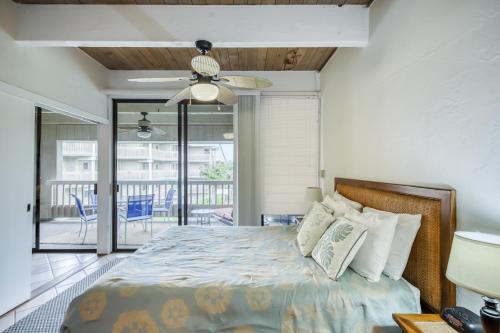 a bedroom with a bed with a ceiling fan at Kona Bali Kai #331 in Kailua-Kona