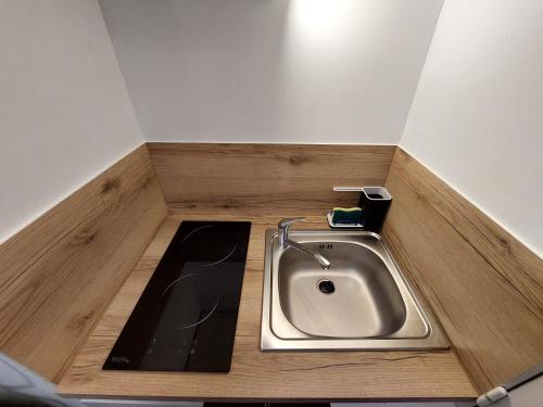 a kitchen with a sink in the floor at Le Studio Zen "parking gratuit" in Cherbourg en Cotentin