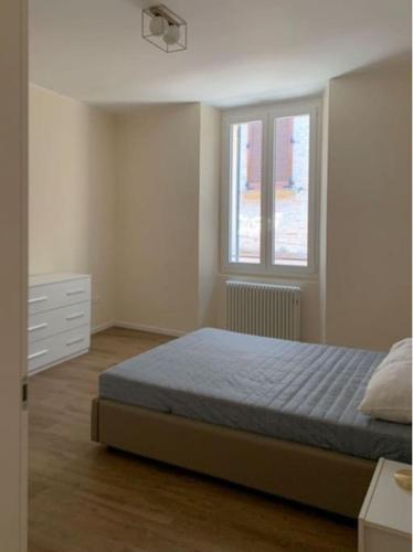 a bedroom with a bed and a window at Appartamento centro storico Nuovo e Ristrutturato in Pesaro
