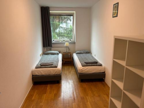 two beds in a small room with a window at 70 square m with balcony+parking+AC in Ljubljana