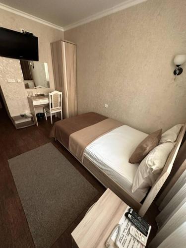 Ένα ή περισσότερα κρεβάτια σε δωμάτιο στο Altyn Adam Hotel