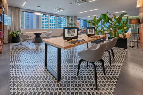 an office with a desk with two computers on it at City Express Plus by Marriott Ciudad de México Santa Fe in Mexico City