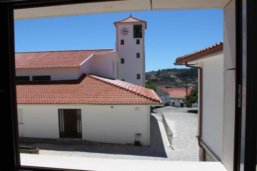 a view from a window of a building with a clock tower at Rito Hall da Serra in Leiria