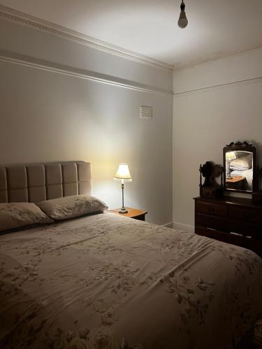 una camera con letto, lampada e specchio di Lough Rynn Home a Mohill