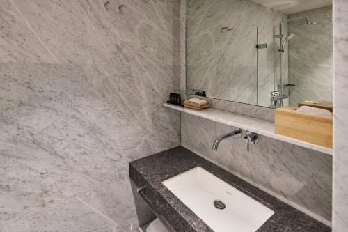 a bathroom with a sink and a mirror at Business Guesthouse in Groningen