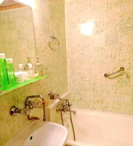 un bagno con un lavandino, una vasca da bagno e un lavandino di Retro CHARME CENTRUM obok szpitala a Białystok