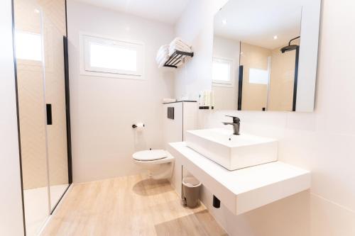 a white bathroom with a sink and a toilet at Houm Villa Nets in Playa de Palma