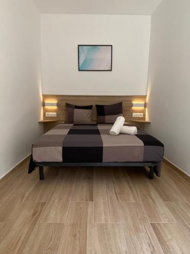 a bed in a room with a wooden floor at VIU BARCELONA BERTRAN in Barcelona