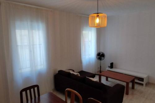 ein Wohnzimmer mit einem Sofa und einem Tisch in der Unterkunft Apartamento al lado del Museo DalÍ in Figueres