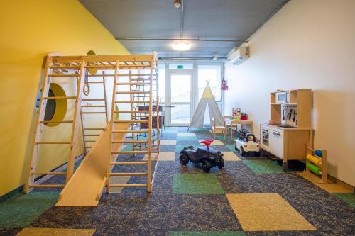 a childrens room with a bunk bed and a slide at Mindaugo apartamentai su šildomu baseinu, sporto sale, vaikų kambariu, work zona in Palanga