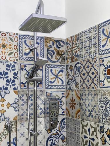 a bathroom with a shower with blue and white tiles at B&B La Limonaia in Tollo