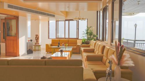 a lobby with couches and tables and windows at Days Inn by Wyndham Gangtok Tadong in Gangtok