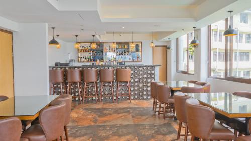 a restaurant with tables and chairs and a bar at Days Inn by Wyndham Gangtok Tadong in Gangtok