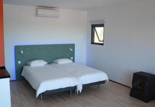 VimieiroにあるBubulcus and Bolotas - Off Grid Nature Holiday Homeのベッドルーム1室(緑のヘッドボード付きのベッド1台付)