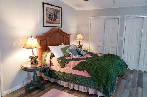 a bedroom with a bed with two lamps and a table at Country Quiet in Sanford