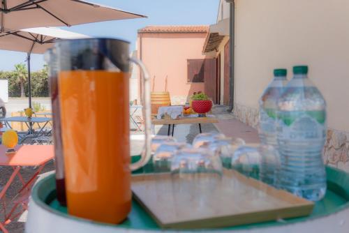 a blender sitting on a table with bottles of water at RUDINI' CHARMING ROOM in Marzamemi