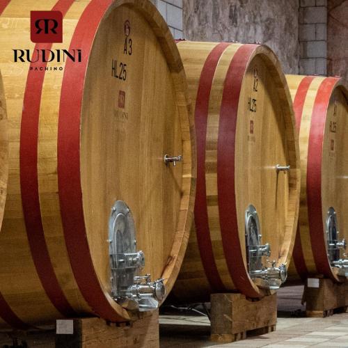 a row of wooden wine barrels in a cellar at RUDINI' CHARMING ROOM in Marzamemi