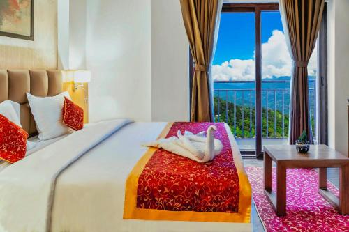 a bedroom with a bed with a view of the ocean at Days Inn by Wyndham Gangtok Tadong in Gangtok