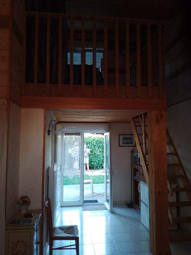 a room with a staircase leading to a house at Chambre in Pontaubault