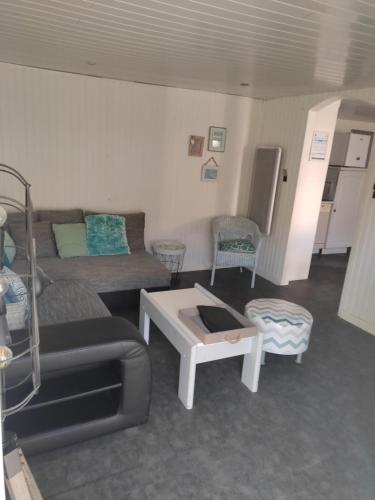 a living room with a couch and a table at Ty Cado in Belz