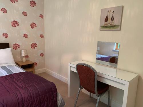 a bedroom with a bed and a desk with a computer at Lough Rynn-Lord Leitrim in Rivers Town