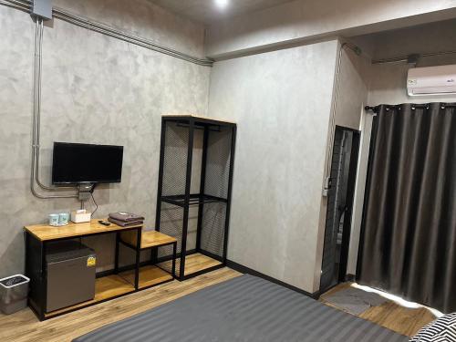 Cette chambre dispose d'une télévision et d'un bureau. dans l'établissement Khampu Resident ก้ามปู เรสซิเด้นท์, à Maha Sarakham