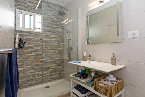 a bathroom with a sink and a shower at 2BR Terrace Home - 10 min walk to the Beach in Playa Honda