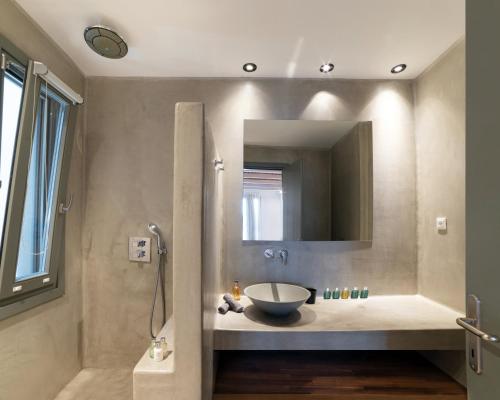 a bathroom with a bowl sink and a mirror at Villa Agavi - Private Pool & Security included - Ideal for events in Mikonos