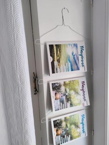 a door with three pictures on the wall at La maison de Miffy in La Chapelle du Chêne