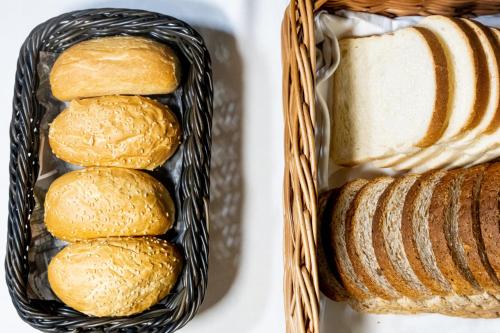 a basket of bread and a basket of breadsticks at The Londoner Hotel Sliema in Sliema