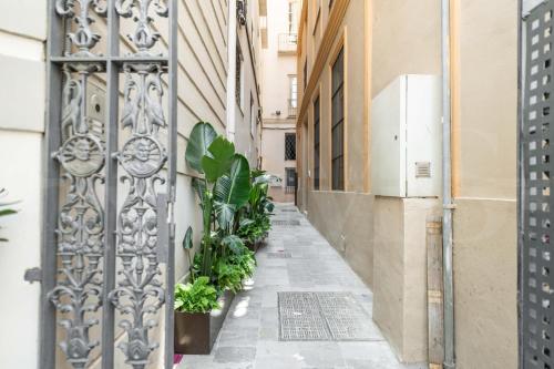 an empty alley with a gate and plants at Deluxe Apartment - Historic Center by REMS in Málaga
