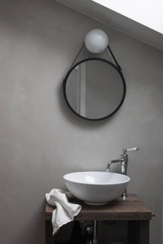 a bathroom with a sink and a mirror on the wall at Siggesta Gård in Värmdö