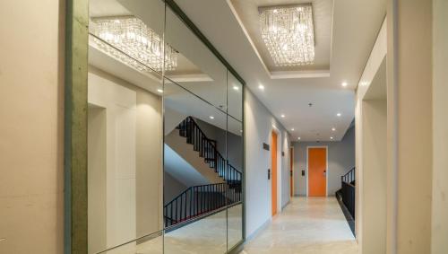 a hallway of a building with a glass wall at Sparrow Hotel Managed by Siara Sariska Alwar in Alwar
