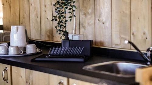 a kitchen with a sink and a counter top with a sink at Lisboa Bungalows in Lisbon
