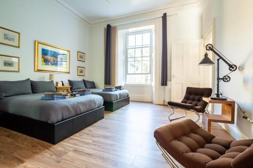 a living room with a couch and a chair at The Heart of Newington in Edinburgh