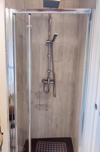 a shower with a glass door in a bathroom at La Casa di Antonietta in Fosdinovo