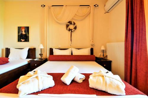 a hotel room with two beds with towels on them at Guesthouse Amanitis Caesarea in Skíti