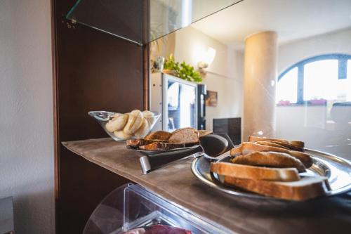 a counter with bread and pastries on top of it at Casa Betania in Pisa
