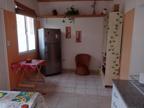 a kitchen with a refrigerator and a table in it at Departamento Independiente Quitilipi in San Salvador de Jujuy
