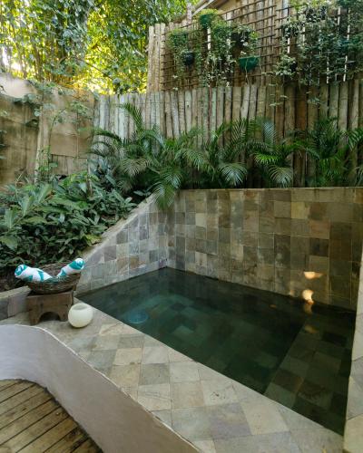 a small swimming pool in a backyard with a fence at DA GRAÇA HOTEL in Trancoso