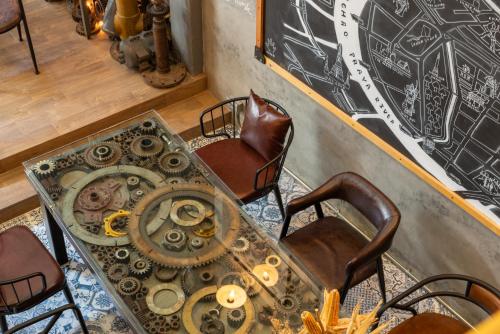 a room with a table and chairs and a chalkboard at House of Machine Boutique Hotel in Bangkok