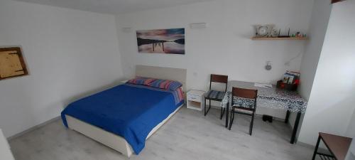 a small bedroom with a bed and a desk at Maison De Marie in Donnaz