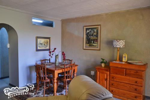 una sala de estar con una mesa y un sofá en Sonata, en Dullstroom