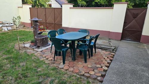 a blue table and chairs sitting on a stone patio at Kod Bake in Novi Bečej