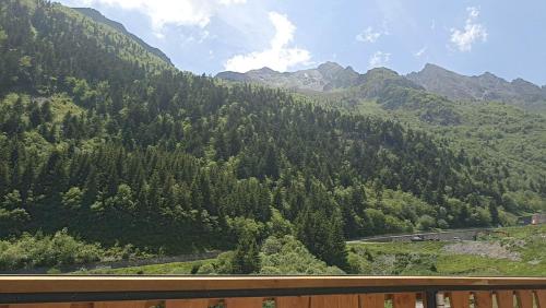a view of a mountain with trees and a road at La Sapinière St Lary Soulan in Saint-Lary-Soulan
