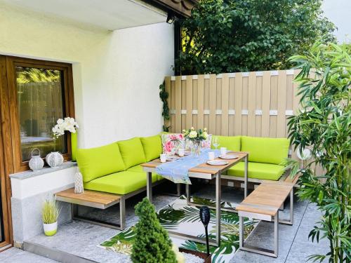 a patio with a table and green furniture at Ursula Maria in Ischgl