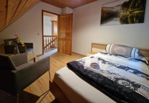 a bedroom with a bed and a wooden floor at Ferienhaus Thymian in Hatten bei Oldenburg - Idyllische Waldlage in Hatten