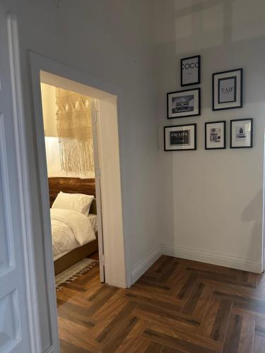 a bedroom with white walls and a bed and a mirror at Dar Sayang in Taif