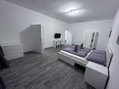 a bedroom with a bed and a desk and a television at Waldluft Apartments in Heidenreichstein